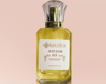 May include: A rectangular glass perfume bottle filled with golden liquid, featuring a clear faceted cap and a gold collar. The white label displays the text Kavelya, NUIT D'OR, 013, and lists ingredients including Tonka, Vanilla, Patchouli, and Jasmine.