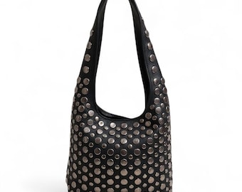 May include: A black hobo-style shoulder bag featuring a rounded silhouette and a single integrated handle. The entire exterior surface is densely covered with circular, metallic silver-toned studs of varying sizes, creating a textured, reflective pattern.