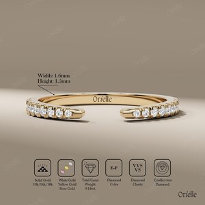 May include: A gold ring with a row of small diamonds. The ring has a width of 1.6mm and a height of 1.5mm. The ring is marked with the brand name "Orielle". The ring is made of solid gold and is available in 10k, 14k, and 18k.
