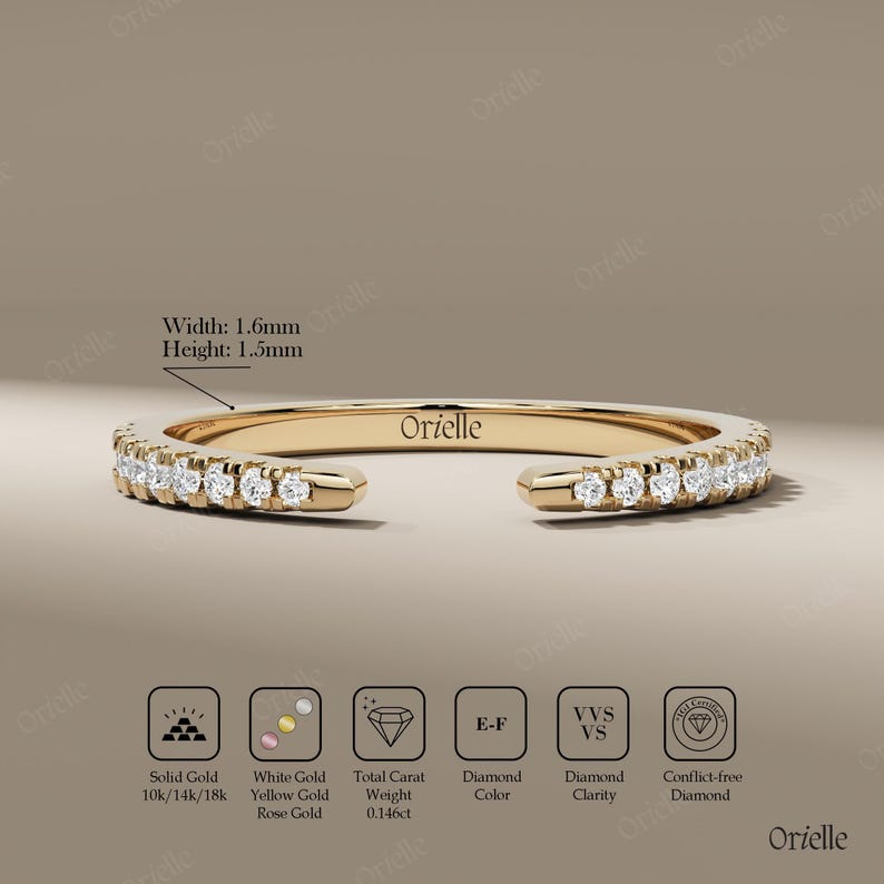 May include: A gold ring with a row of small diamonds. The ring has a width of 1.6mm and a height of 1.5mm. The ring is marked with the brand name "Orielle". The ring is made of solid gold and is available in 10k, 14k, and 18k.