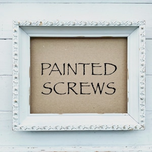 May include: White painted frame with a brown paper insert and the text "PAINTED SCREWS" in black.