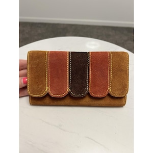 May include: A set of three ceramic vases in varying heights. The vases have a matte finish in shades of cream, beige, and brown. The tallest vase is approximately 10 inches high.