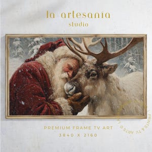 Peut inclure: Impression d'art numérique encadrée représentant le Père Noël étreignant un renne dans une forêt enneigée. Le Père Noël porte un manteau et un chapeau rouges avec une garniture en fourrure blanche. Le texte "la artesanía studio" est en haut.