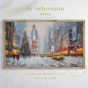 May include: A framed painting of a snowy New York City street scene at night. The artwork features a Christmas tree, yellow taxis, and illuminated buildings. The painting is labeled "la artesanía studio" and "PREMIUM FRAME TV ART 3840 X 2160".