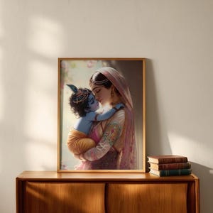 A framed painting of a woman embracing a child is displayed on a wooden cabinet against a white wall.