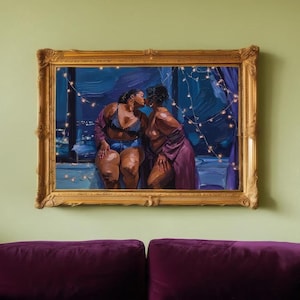 a painting of two women in a romantic embrace, hanging on a green wall above a purple couch.