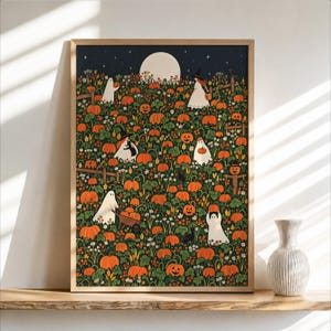 May include: A framed rectangular wall art print featuring a dark night sky with a full moon over a pumpkin patch. The illustration depicts ghosts, figures in witch hats, and black cats among orange pumpkins, green vines, and small white flowers.