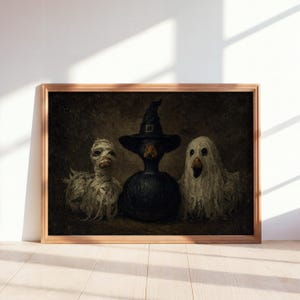 May include: A framed wall art print featuring three ducks in Halloween costumes against a dark background. The left duck is wrapped in white bandages like a mummy, the center duck wears a black witch hat, and the right duck is draped in a white sheet.