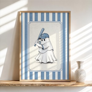 May include: A framed wall art print featuring a white ghost character wearing a blue baseball cap with the letter H and a matching jersey, holding a blue baseball bat. The background has a light blue and white vertical striped border.