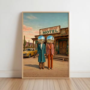 May include: A framed art print depicting two figures with reflective chrome sphere heads standing before a wooden Desert Dream Motel building. One figure wears a teal coat, the other a rust-colored suit. A yellow vintage car and cacti are visible.