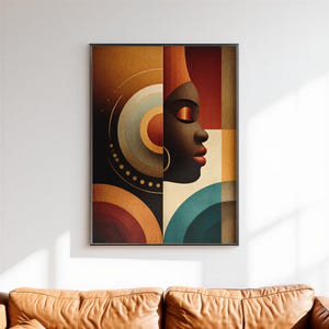 May include: Abstract art print depicting a Black woman's profile with a red lip and gold earring. The artwork uses geometric shapes and warm colours such as brown, orange, and teal. The art is framed in a black frame.