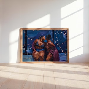 May include: A framed art print depicting two individuals kissing in a room at night. One person wears a black lace bra and blue denim shorts, while the other wears a purple robe. String lights hang in the background against a dark blue window.