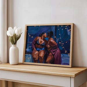 May include: A framed art print depicting two individuals kissing in a dimly lit room with string lights. One person wears a dark lace bralette and denim shorts, while the other wears a purple robe. The scene is set against a deep blue background.