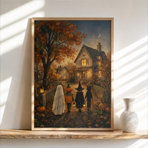 May include: A framed wall art print depicting four children in Halloween costumes walking up a path toward a lit house at twilight. The scene features a large autumn tree with orange leaves, a white picket fence, pumpkins, and a crescent moon.