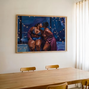 May include: A rectangular framed wall art print featuring an oil painting of two figures embracing in front of a dark blue window at night. The scene is illuminated by thin strings of warm glowing fairy lights draped across the dark background.