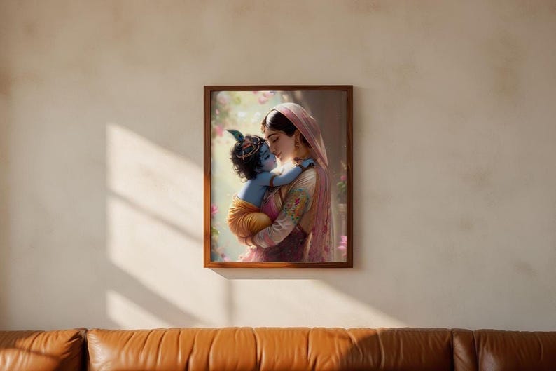 A framed photograph of a woman embracing a child, likely a baby, is hanging on a wall above a brown leather couch.