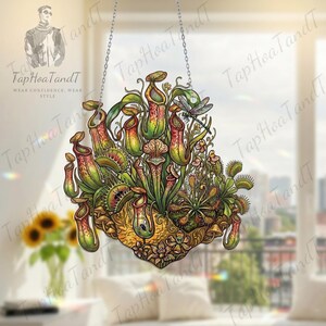 May include: A decorative hanging artwork depicting carnivorous plants, such as pitcher plants and Venus flytraps. The illustration uses green, red, and yellow hues, with a dragonfly and floral details. It is suspended by a silver chain.