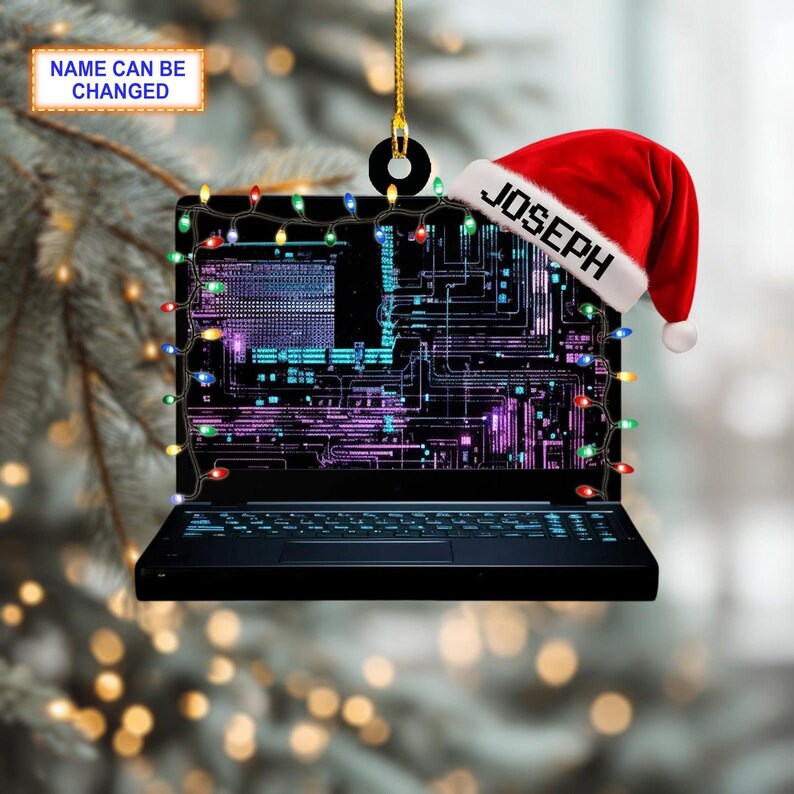 May include: A black laptop Christmas ornament with a Santa hat that says "JOSEPH". The laptop screen displays a circuit board design and is decorated with colorful string lights. The text "NAME CAN BE CHANGED" is also visible.