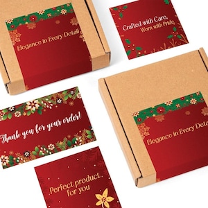 May include: Cardboard boxes with red labels featuring holiday floral designs and text. The labels read "Elegance in Every Detail," "Crafted with Care, Worn with Pride," "Thank you for your order!" and "Perfect product. for you."