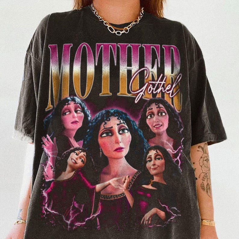 May include: Dark gray t-shirt featuring the text "MOTHER Gothel" above a graphic of the character Gothel from the animated film Tangled. The graphic includes multiple images of Gothel in various poses, with a purple and pink color scheme.