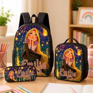 May include: A black backpack, lunch bag, and pencil case set featuring a graphic of a long-haired character in a boat surrounded by floating lanterns. Each item displays the name Emilia in purple script text against a dark, starry night background.