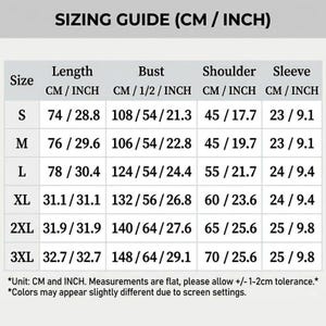 May include: A sizing guide chart with black text on a white background. The table lists sizes S through 3XL with corresponding length, bust, shoulder, and sleeve measurements in centimeters and inches. Includes a disclaimer about measurement tolerance.