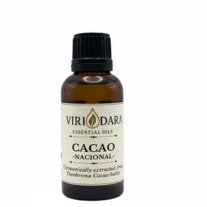 May include: A brown glass bottle of essential oil with a black cap. The label reads "Viri Dara Essential Oils Cacao Nacional" with text about the extraction process. The bottle contains a dark amber liquid.