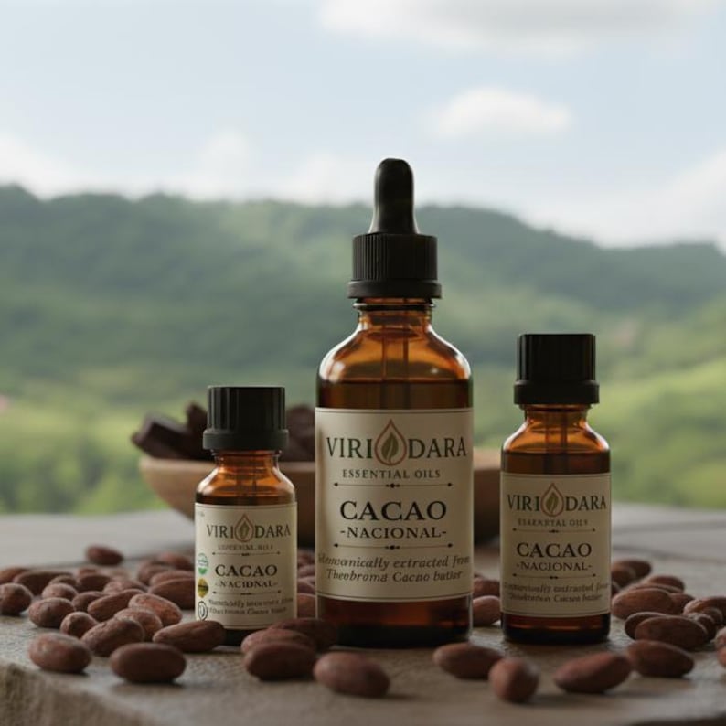 May include: Three amber glass bottles of essential oil with black caps and droppers, labelled "Cacao - Nacional." Cocoa beans surround the bottles. The background features a blurred green landscape and a wooden bowl with chocolate.