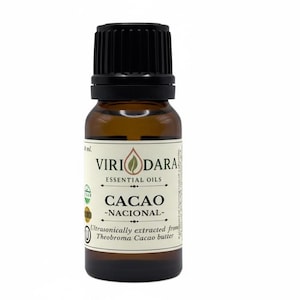 May include: A brown glass bottle of cacao essential oil with a black cap. The label reads "Viri Dara Essential Oils" and "Cacao - Nacional-". The text "Ultrasonically extracted from Theobroma Cacao butter" is also visible.