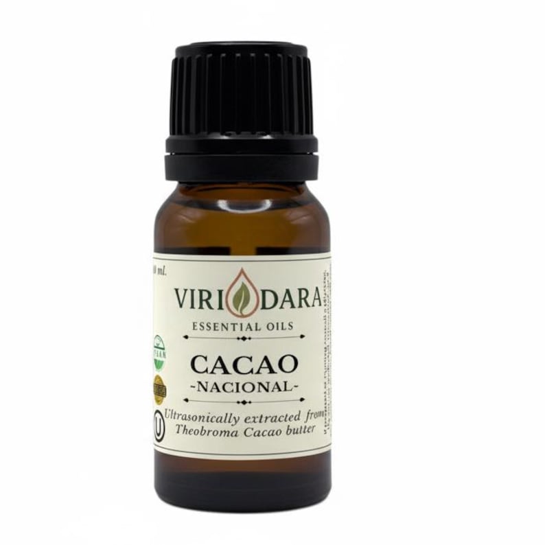 May include: A brown glass bottle of cacao essential oil with a black cap. The label reads "Viri Dara Essential Oils" and "Cacao - Nacional-". The text "Ultrasonically extracted from Theobroma Cacao butter" is also visible.
