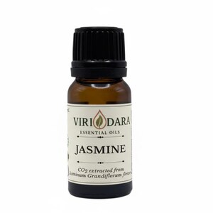 May include: A small amber glass bottle of jasmine essential oil with a black cap. The label reads "Viri Dara Essential Oils" and "Jasmine". The bottom of the label states "CO2 extracted from Jasminum Grandiflorum flowers".