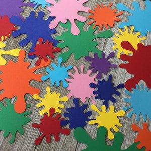 May include: A collection of colorful paper paint splatters in various sizes. The splatters are in shades of red, orange, yellow, green, blue, purple, and pink.