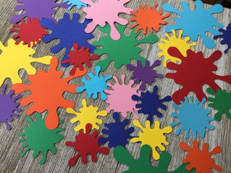 May include: A collection of colorful paper paint splatters in various sizes. The splatters are in shades of red, orange, yellow, green, blue, purple, and pink.
