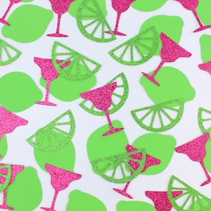 May include: A pattern of pink glitter martini glasses and green glitter lime slices on a white background. The lime slices and martini glasses are scattered across the surface, creating a festive and playful design.
