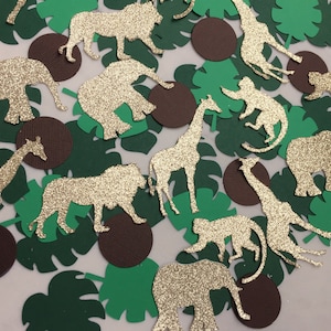 May include: Assortment of gold glitter animal cutouts, including a lion, giraffe, elephant, monkey, and leaves. The cutouts are perfect for party decorations or crafting projects.