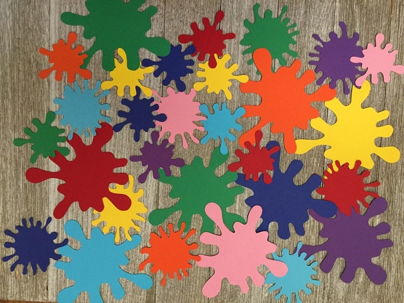 May include: A collection of colorful paper paint splatters in various sizes. The splatters are in shades of red, orange, yellow, green, blue, purple, and pink.