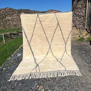 May include: A rustic wooden sign with the text "Welcome to our home" in white lettering. The sign features a distressed finish and a simple, inviting design, perfect for a front porch or entryway.