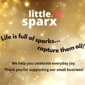 May include: A gold-toned background with sparkling bokeh effects. The text "little sparx" is at the top, with a red starburst. Below, it reads "Life is full of sparks... capture them all!" and "We help you celebrate everyday joy."