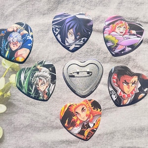 May include: A collection of heart-shaped pinback buttons featuring colorful anime character illustrations. The buttons showcase various characters with detailed artwork and vibrant colors, perfect for fans of the series.