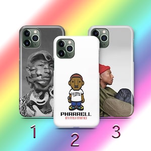 Puede incluir: Tres fundas de teléfono con diferentes diseños. Una funda es en blanco y negro con un retrato fragmentado. Otra es blanca con una figura de dibujos animados y el texto "PHARRELL IN MY MIND". La tercera tiene un perfil.