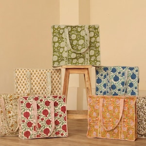May include: A selection of patterned tote bags. The bags feature floral and fruit designs in shades of green, blue, red, and orange. Each bag has a matching handle. Ideal for shopping or carrying everyday essentials, these bags offer a stylish storage solution.