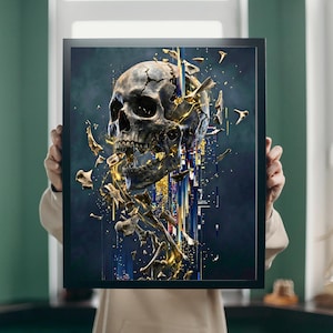 May include: A framed art print featuring a detailed, grayscale skull with golden accents and fragmented bone elements. The artwork has a dark, moody background with vertical streaks of color, creating a dramatic and artistic effect. The print is held by a person.