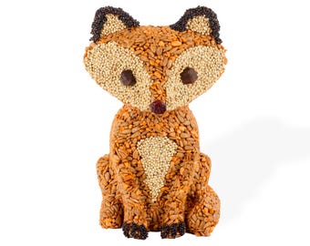 May include: A fox-shaped food item made from various seeds and grains. The fox has a light brown body, a white chest, and a face with dark brown eyes. The ears are black, and the nose is a small, red berry. The fox is sitting upright.