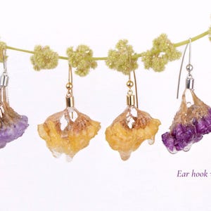 May include: Earrings with dried flower petals in shades of purple and yellow, suspended from silver and gold hooks. Some earrings have a Venetian chain. The text "Venetian chain" and "Ear hook with ball" are visible.