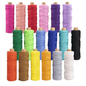 May include: A selection of colourful macram&eacute; cords in shades of pink, red, purple, green, blue, yellow, brown, grey, and black. Each cord is wound around a cardboard spool, providing a range of options for craft projects.