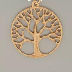 May include: Gold-coloured pendant with a tree of life design. The circular pendant has an openwork pattern showing the tree's branches and roots. It has a small loop at the top for a chain or cord.