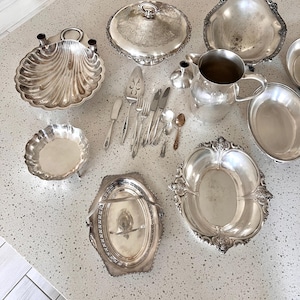 May include: A set of three ceramic mugs with a speckled, matte finish. The mugs are in shades of cream, light gray, and dark gray. Each mug has a simple, minimalist design, perfect for coffee or tea.