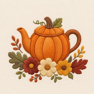 May include: An embroidery design featuring a central orange pumpkin-shaped teapot with a brown stem lid and handle. The teapot is surrounded by a decorative arrangement of autumn-colored flowers, including red, cream, and yellow blossoms, green oak leaves, and small red berries on a light fabric background.