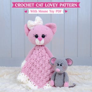 May include: A crochet cat lovey with a pink head, white muzzle, and a white bow, attached to a pink textured blanket with a white border. Beside it sits a small grey crochet mouse toy. Text reads: CROCHET CAT LOVEY PATTERN With Mouse Toy PDF.