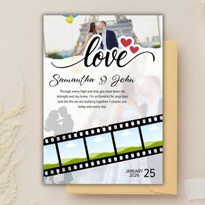 May include: Wedding invitation featuring a photo of a couple kissing in front of the Eiffel Tower. The word "love" is written in cursive above the couple's names, with red heart accents. The date is January 25, 2026.